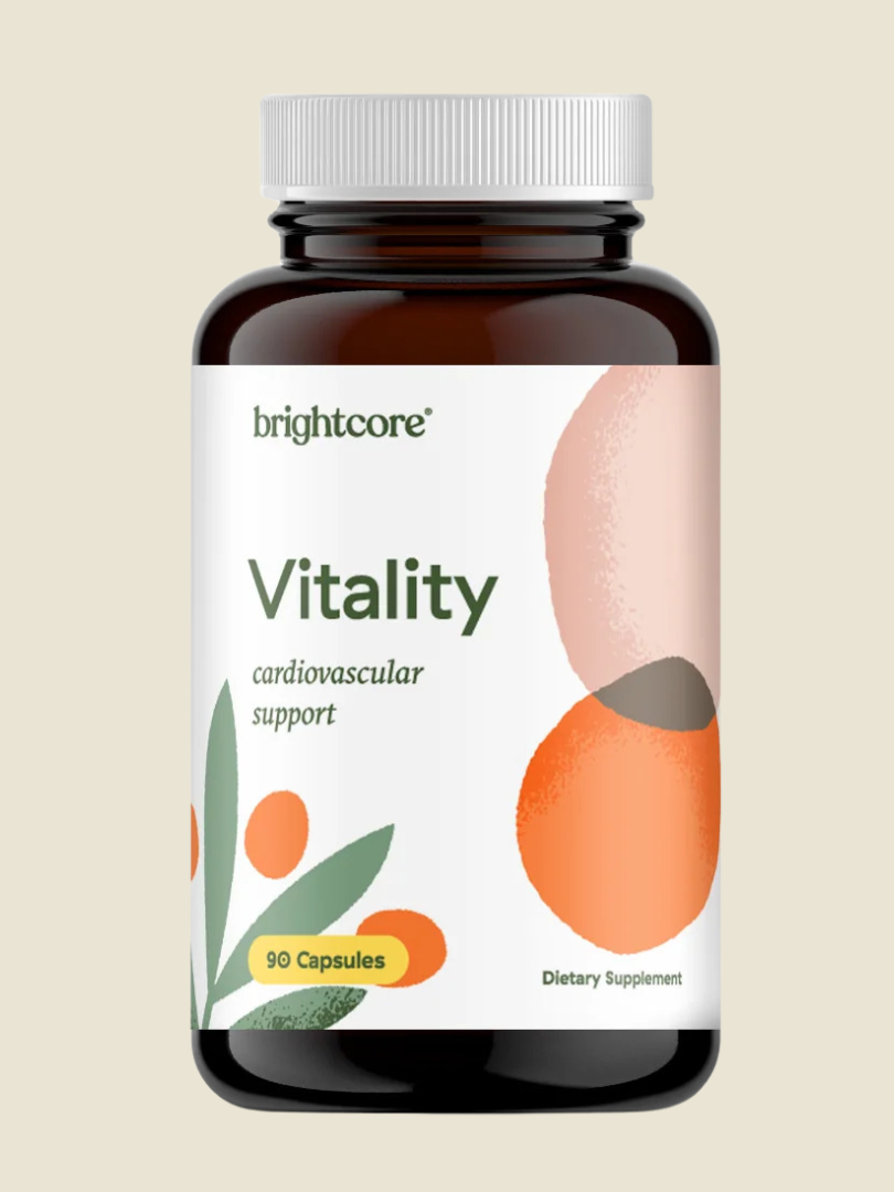 A dark amber bottle labeled "brightcore® Vitality cardiovascular support," containing 90 capsules. The label features abstract orange and green designs.