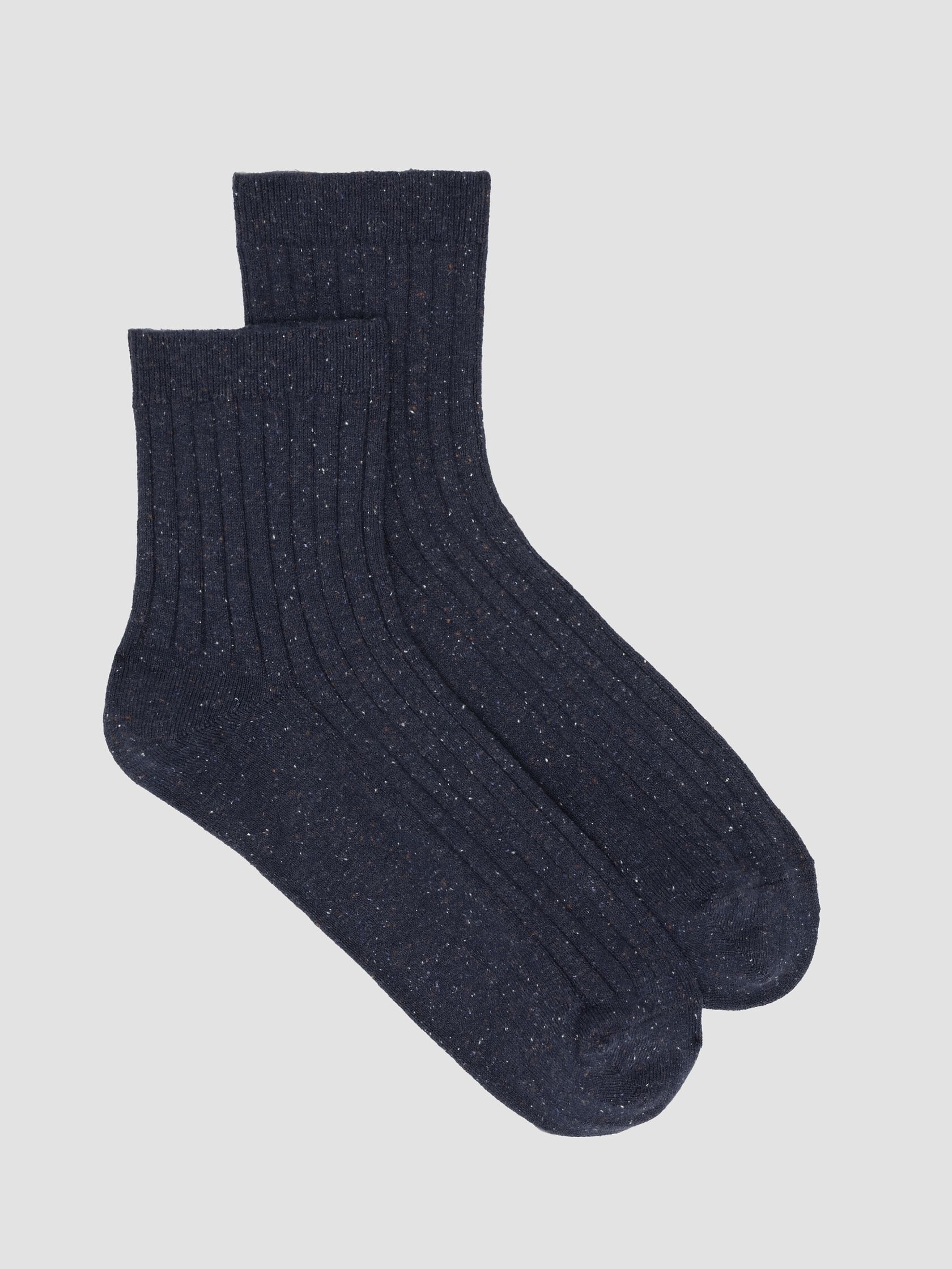 A pair of dark blue, ribbed organic socks with a slight speckled pattern, placed overlapping on a light gray background.