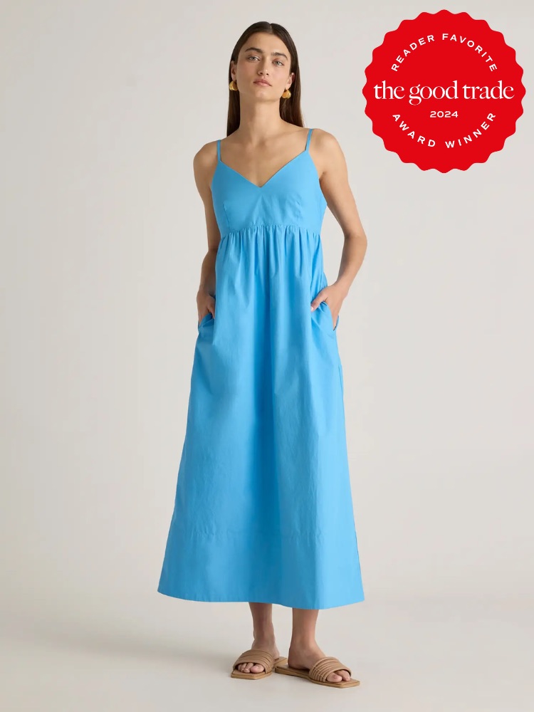 Woman in a blue sleeveless dress stands with hands in pockets. She wears sandals and faces forward. A red badge on the image reads "Reader Favorite. The Good Trade. 2024 Award Winner.