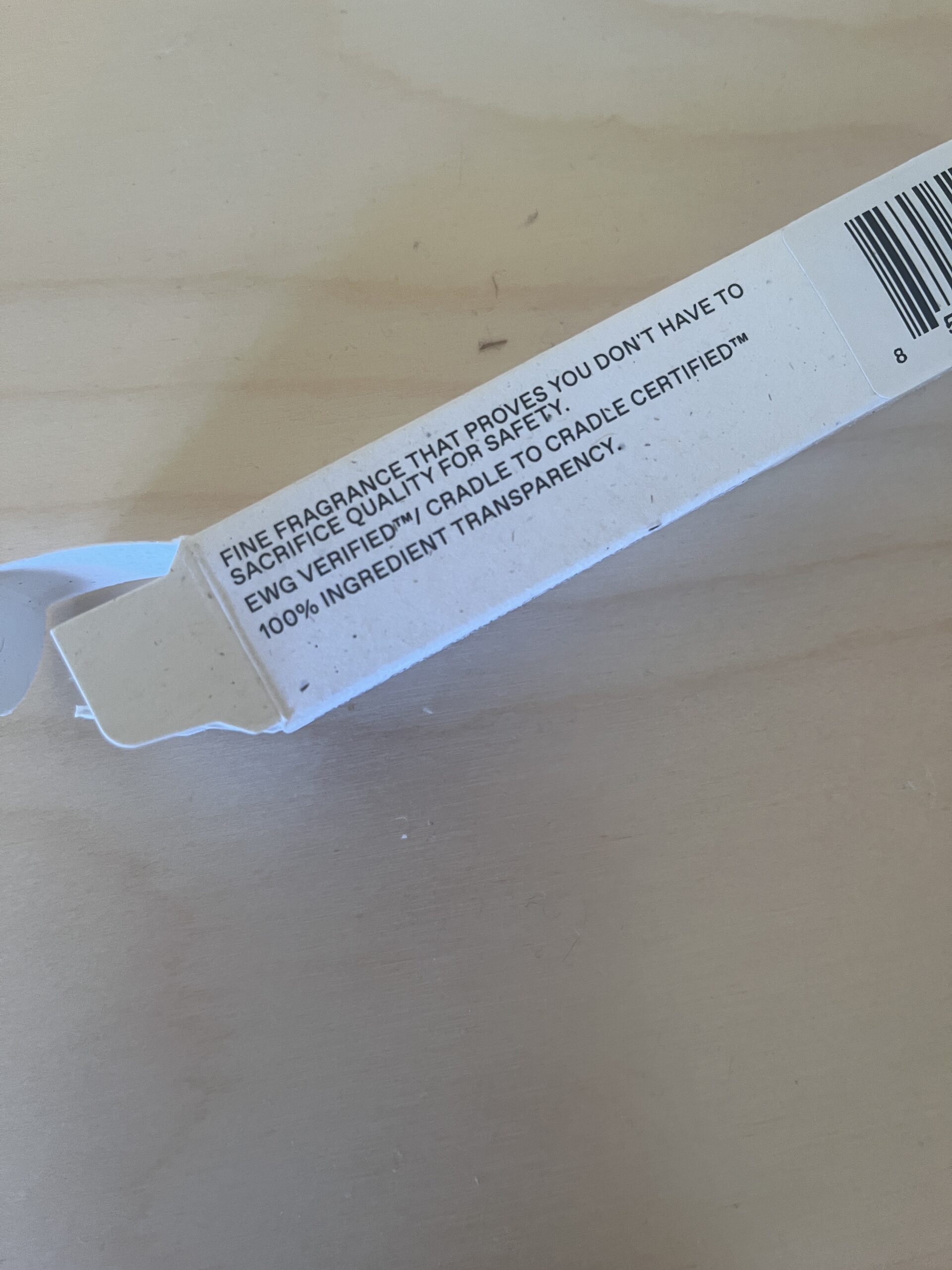 Text on a cardboard box reads: "Fine fragrance that proves you don't have to sacrifice quality for safety. Engineered for Cradle-to-Cradle Certified™ 100% ingredient transparency.