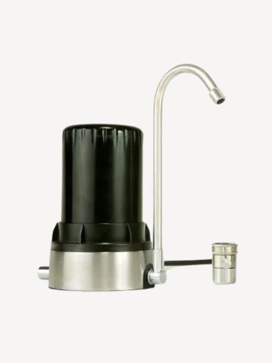 A countertop water filter with a black cylindrical body and a curved metal spout.