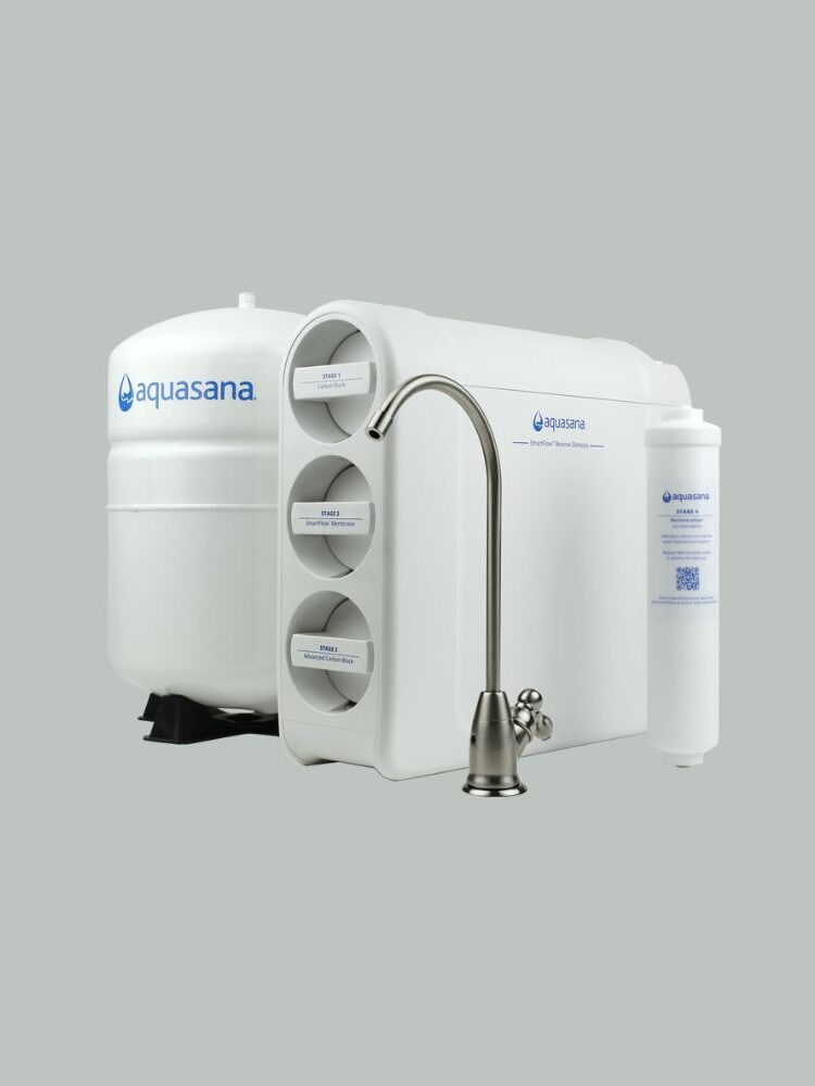 A white Aquasana water filtration system with multiple cylindrical components and a metal faucet attachment. The system includes a large container and several filter cartridges.