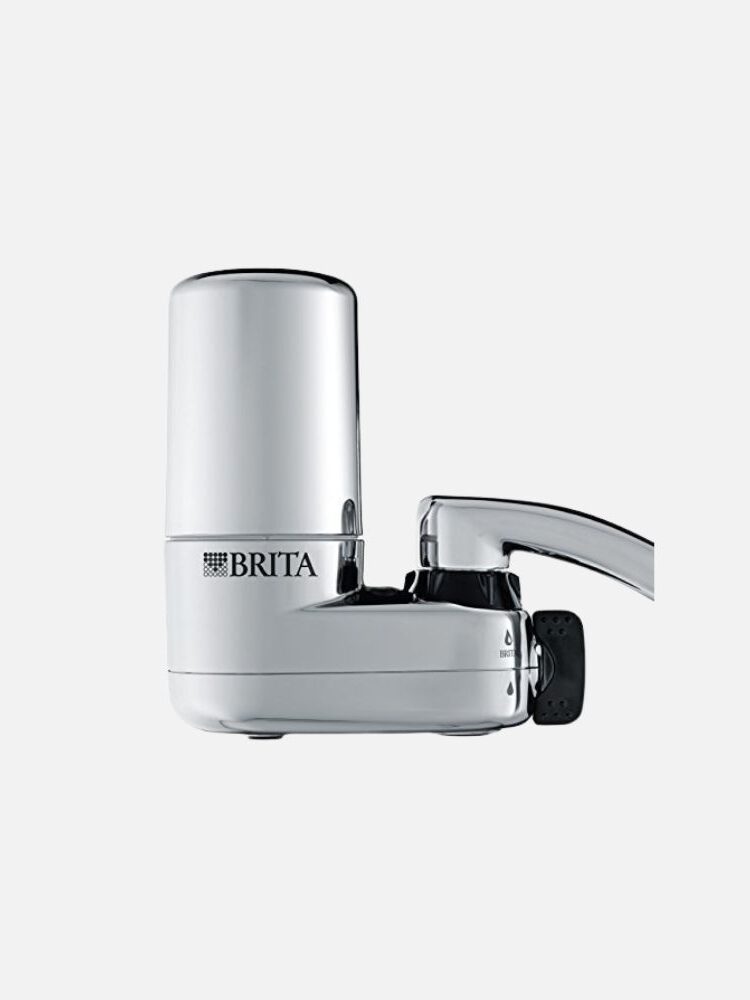 Close-up of a Brita faucet water filter in a sleek silver finish, attached to a faucet, designed to purify tap water for drinking.