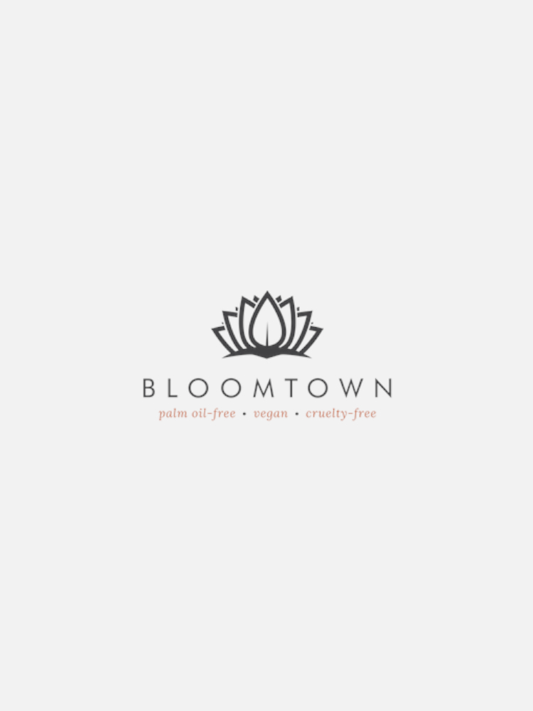 The image displays the Bloomtown logo consisting of a stylized lotus flower above the company name. Below it, text reads: "palm oil-free • vegan • cruelty-free.