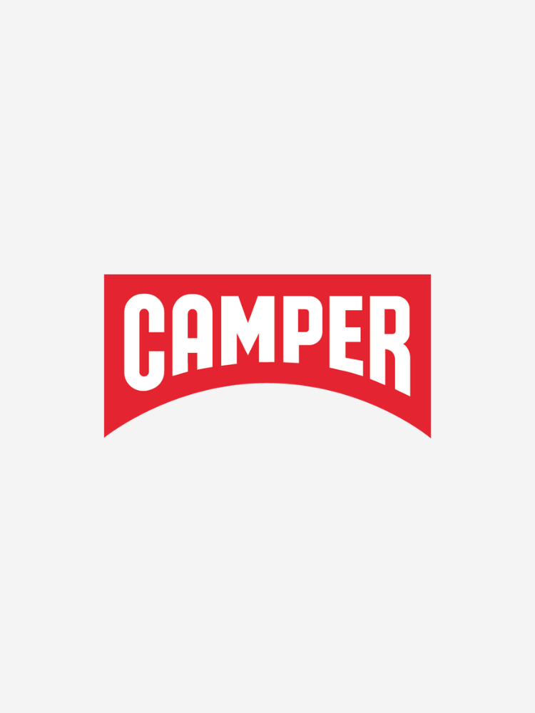 A red logo with the word "Camper" in bold white letters, enclosed in a rounded rectangular shape.