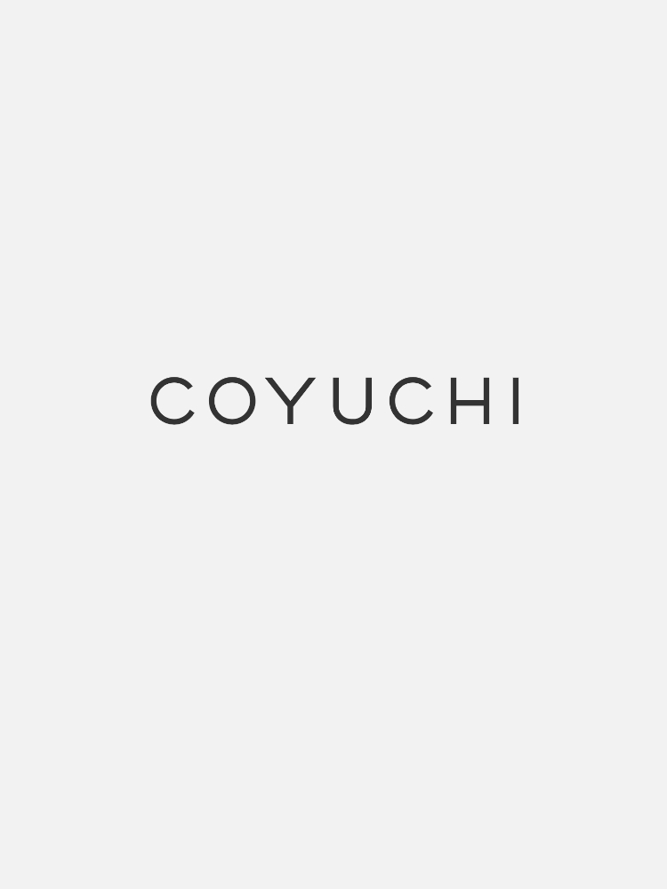 Text "COYUCHI" in all capital letters is centered against a plain, light gray background.