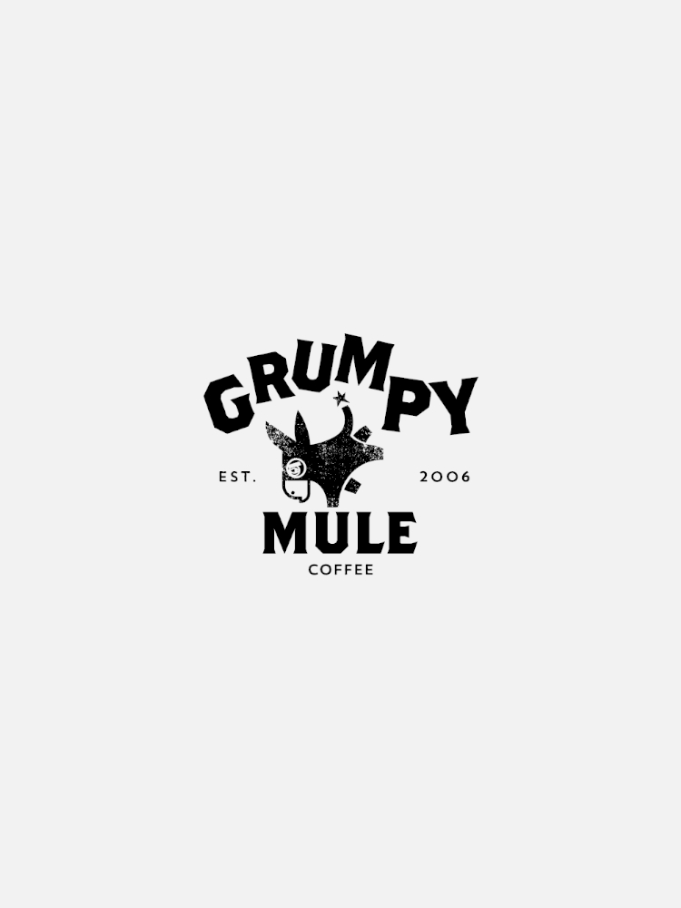 A black and white logo with the text "Grumpy Mule Coffee, Est. 2006" and an image of a mule.