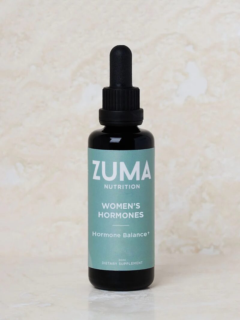 A bottle of Zuma Nutrition Women's Hormones dietary supplement with a dropper, labeled "Hormone Balance.