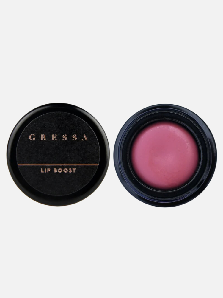 Open round black container showing pink lip balm alongside its closed cap labeled "Gressa Lip Boost.