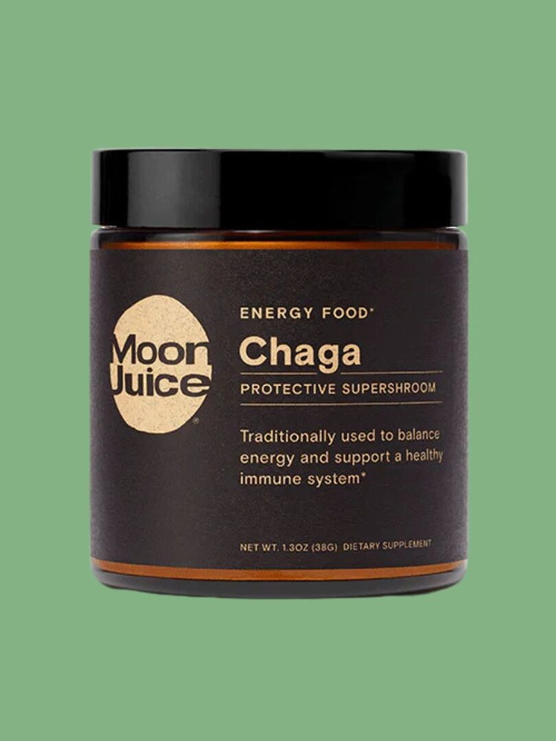 A jar labeled "Moon Juice Chaga" with "Energy Food" and "Protective Supershroom" written on it, against a green background. The product is marketed to support energy and a healthy immune system.