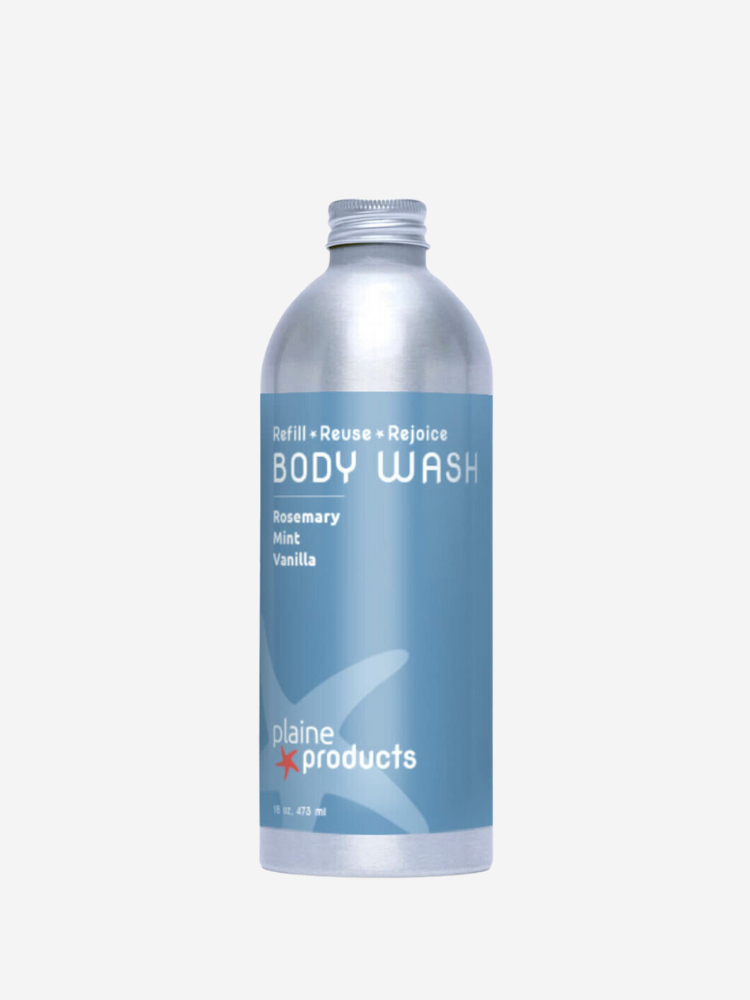 A silver aluminum bottle with light blue labeling, containing Plaine Products body wash with rosemary, mint, and vanilla. The label also includes the message "Refill, Reuse, Rejoice.