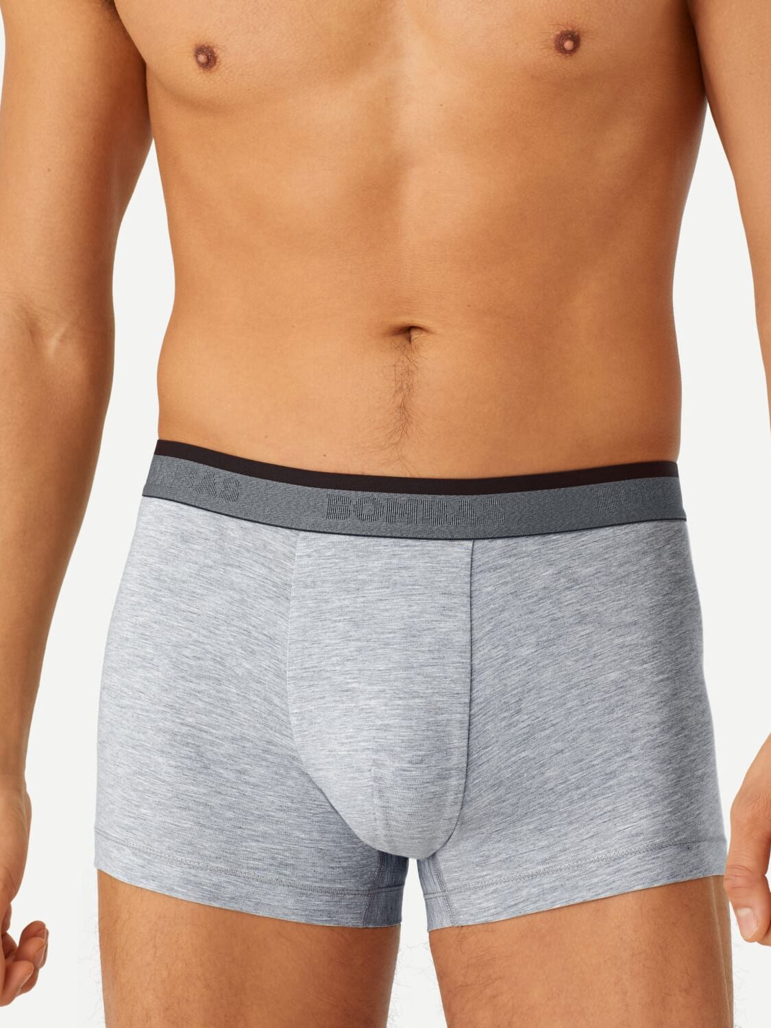 A person wearing gray boxer briefs with a black waistband. Only the lower torso and thighs are visible.