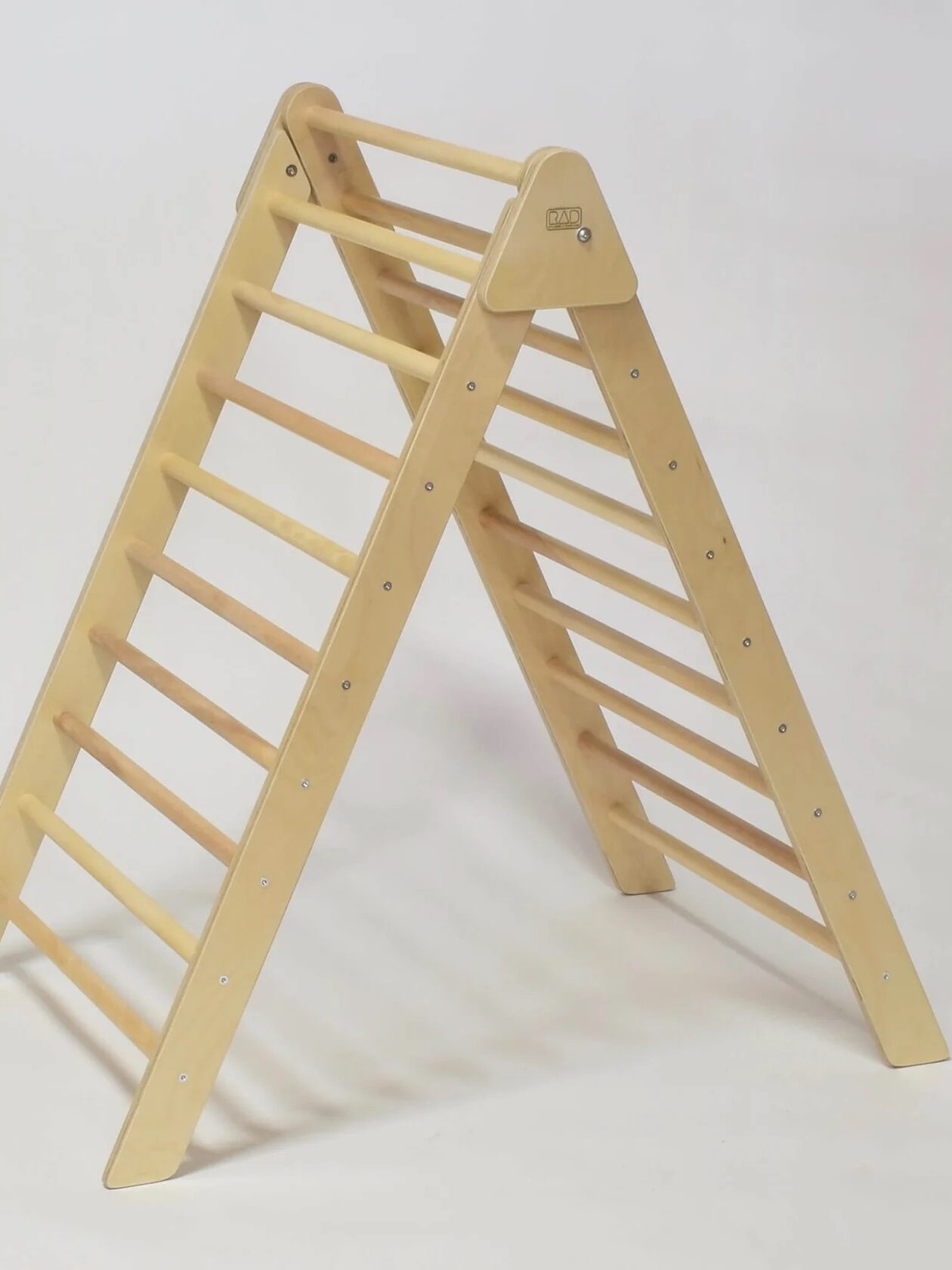 A wooden climbing triangle with rungs, designed for children's indoor play.