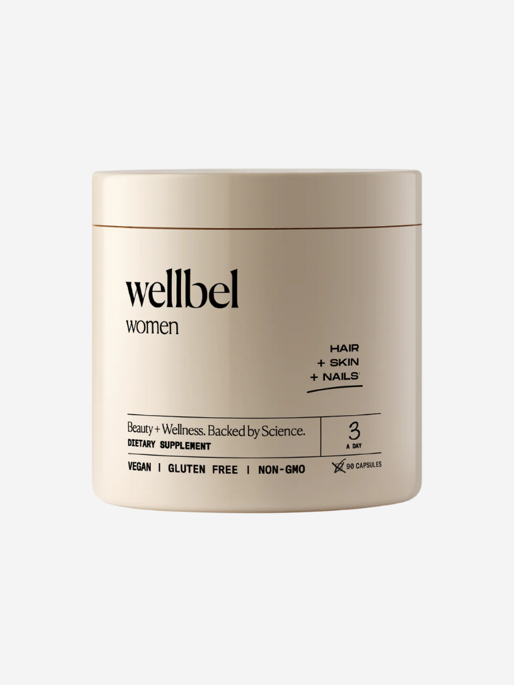 A beige container labeled "wellbel women," a dietary supplement for hair, skin, and nails. It highlights being vegan, gluten-free, and non-GMO, with a dosage of three capsules daily.