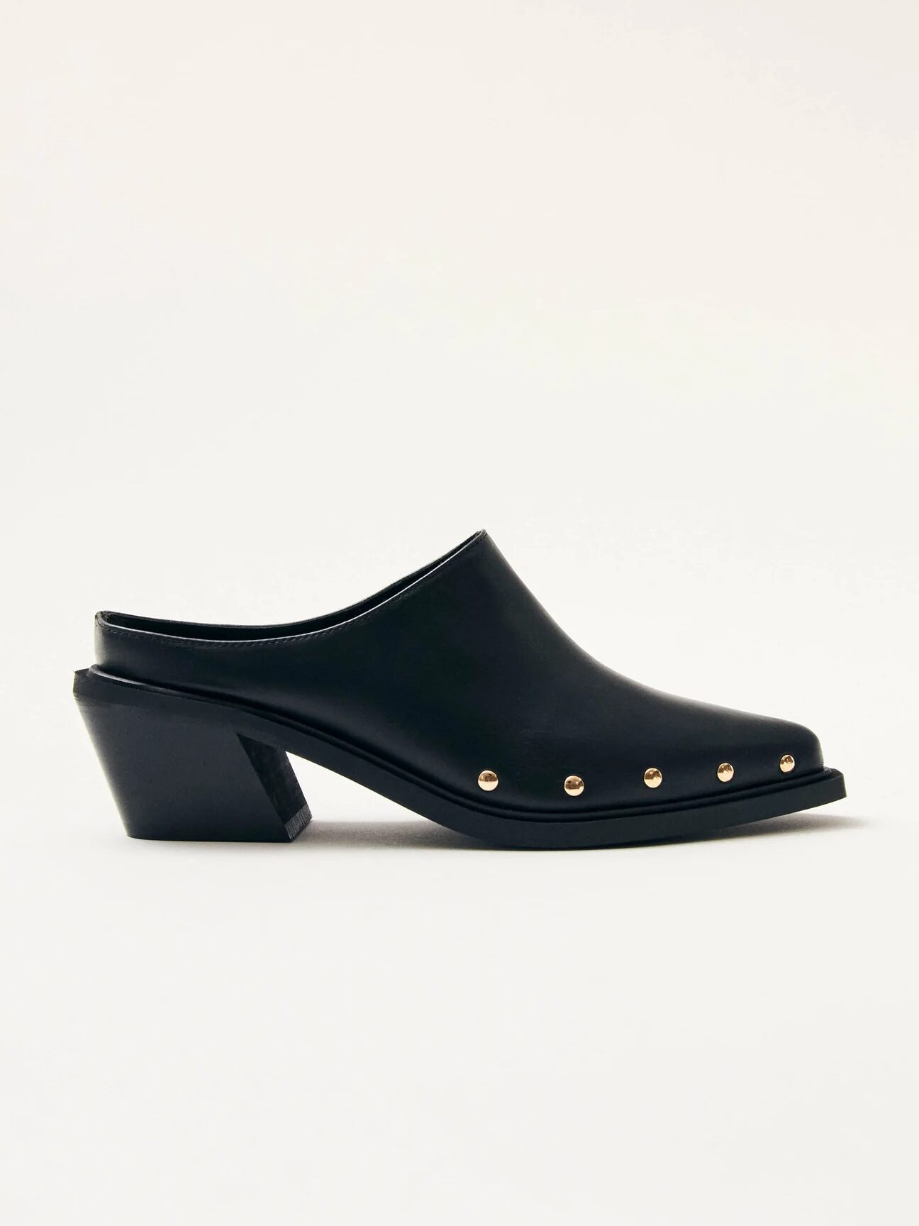 A side view of a black leather mule with a block heel and gold stud embellishments along the edge.