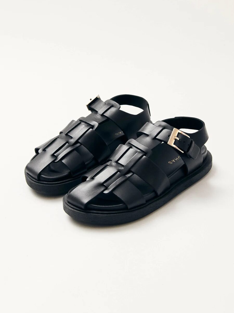 A pair of black, strappy open-toe sandals with a buckle closure, displayed on a white background.