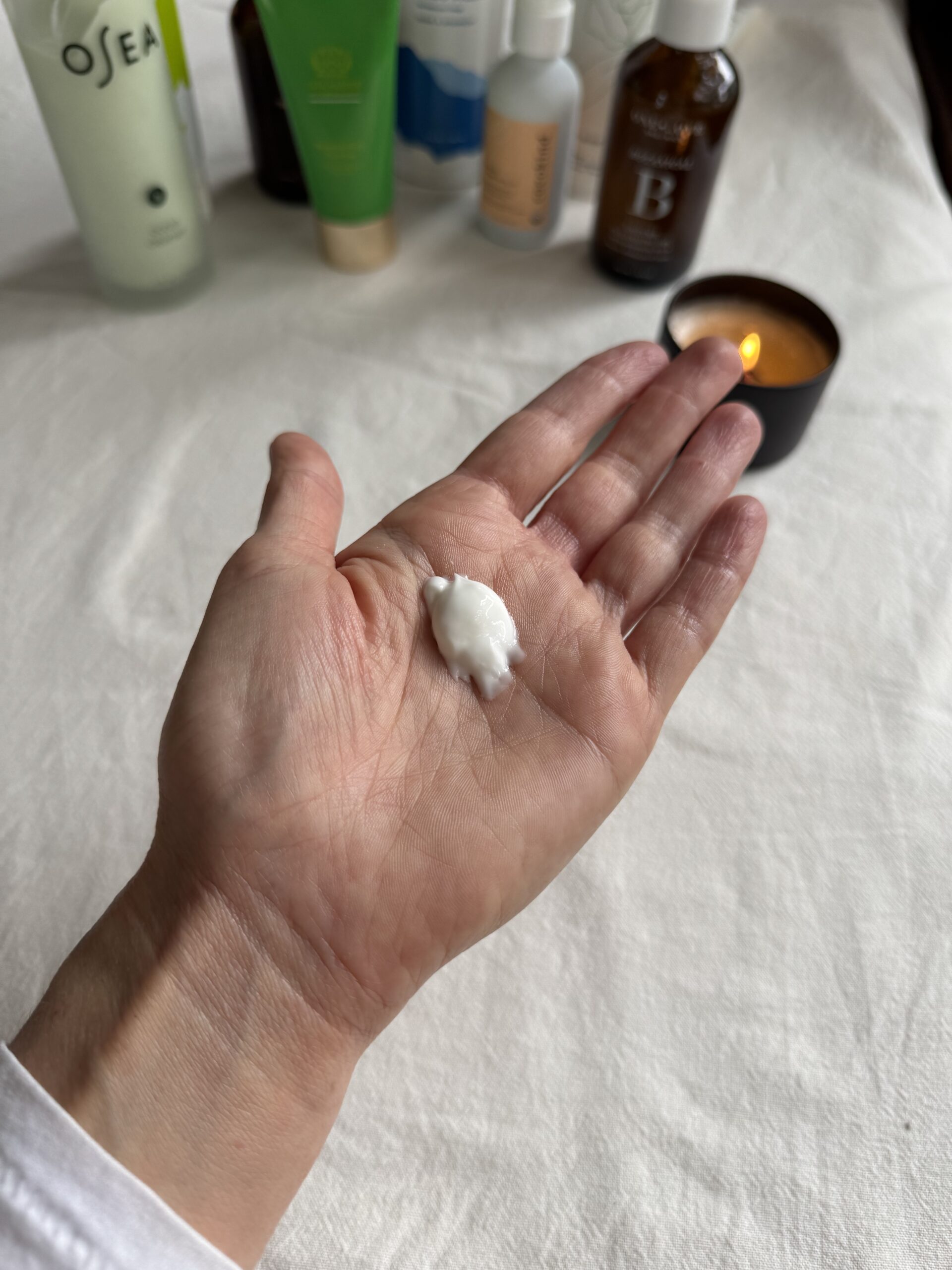 A hand with a small amount of Pai face wash in the palm.