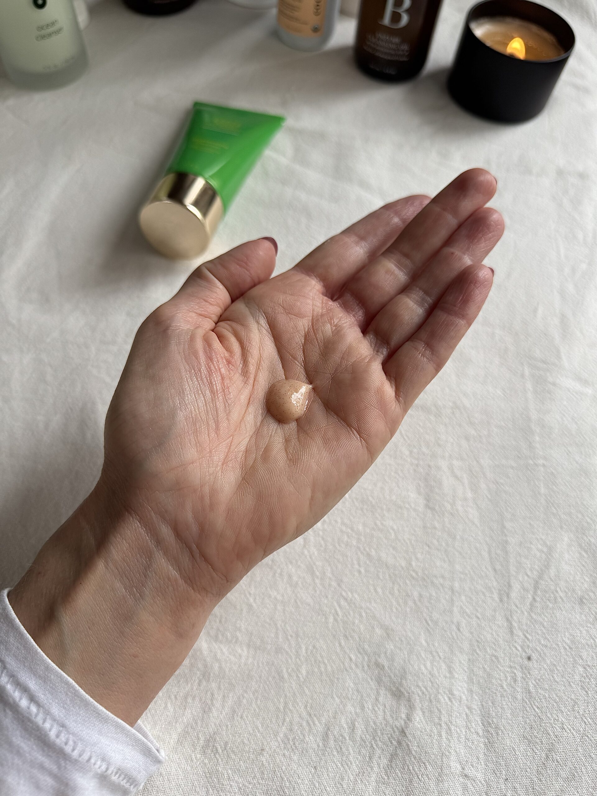 A hand with a small amount of Tata Harper face wash in the palm.