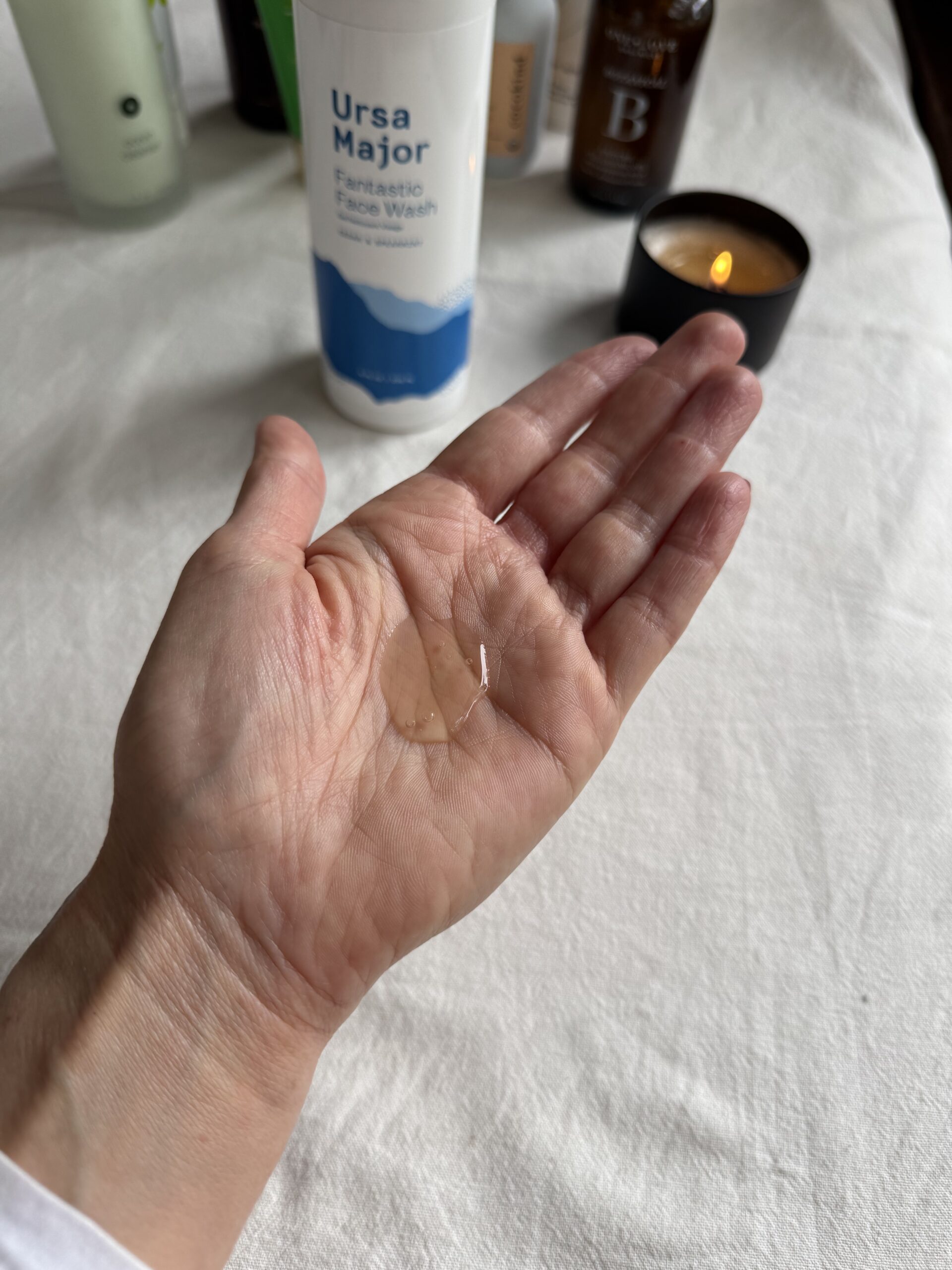 A hand with a small amount of Ursa Major face wash in the palm.