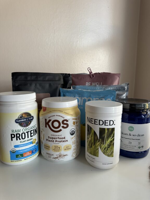 Assorted protein supplement containers on a shelf.