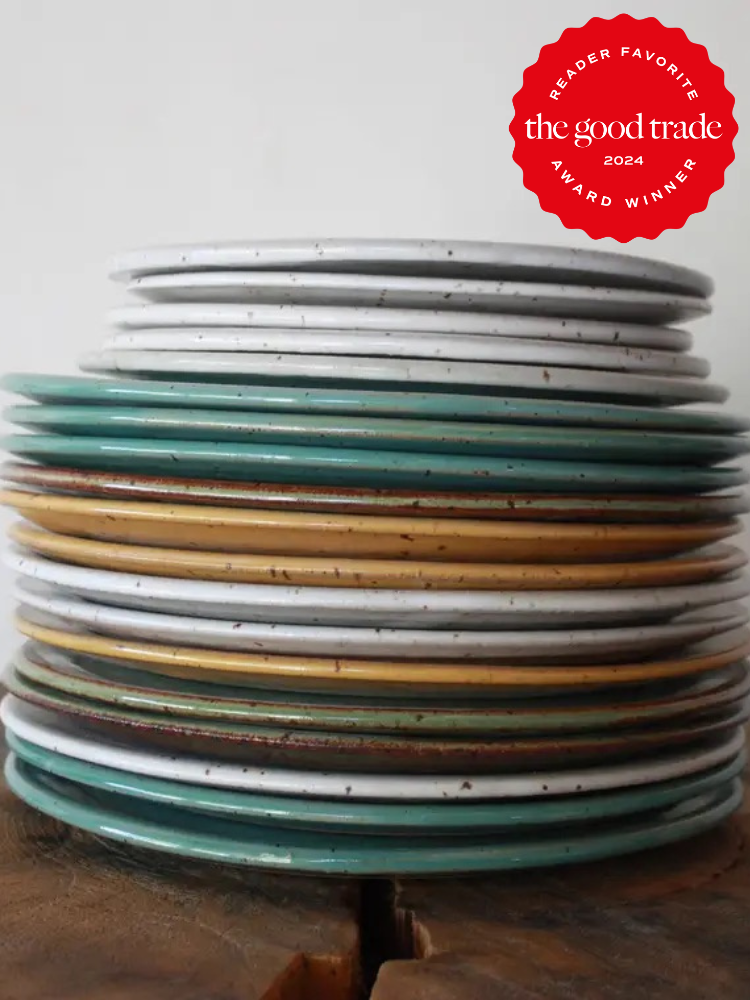 A stack of multicolored ceramic plates with a "Reader Favorite The Good Trade Award Winner 2024" badge in the upper right corner.