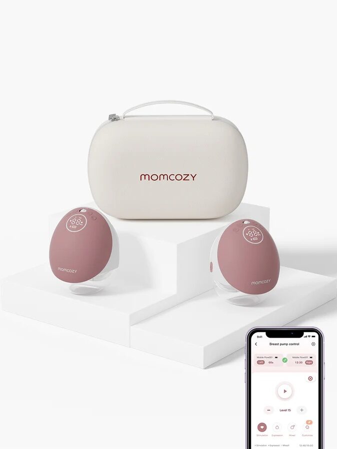 A Momcozy breast pump set with two pump units, a carrying case, and a smartphone displaying the control app.