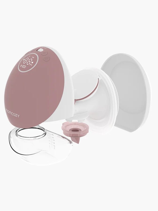 A disassembled breast pump with a pink and white color scheme featuring various detachable components including a motor, tubing, and silicone breast shield.