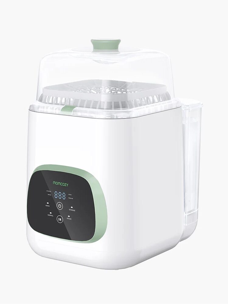 A white and green baby bottle sterilizer with a digital display in the front and a transparent lid on top.