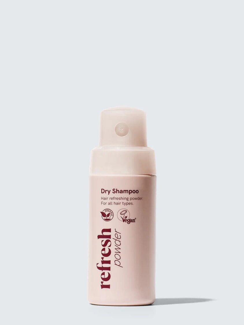 A beige bottle of vegan Refresh Powder dry shampoo for all hair types against a plain background.