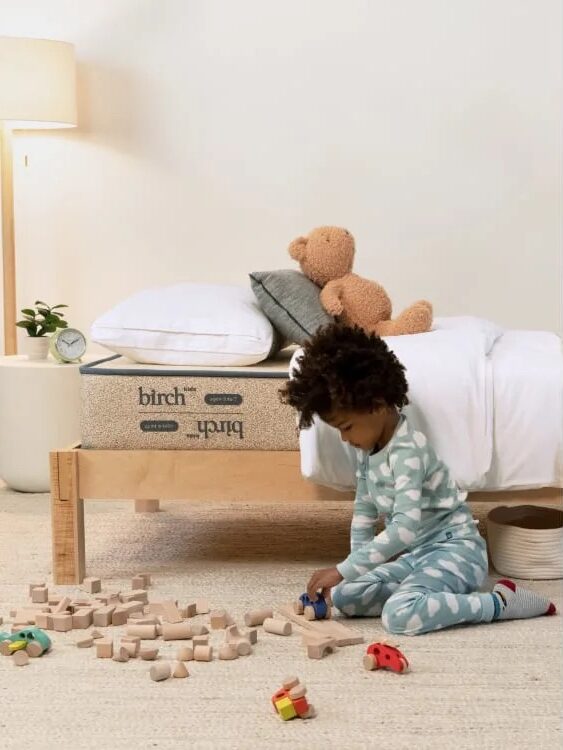 Three images showing a child's bedroom: a child playing with wooden blocks near a bed, scattered blocks on the floor, a neatly made bed with a "birch kids" mattress.