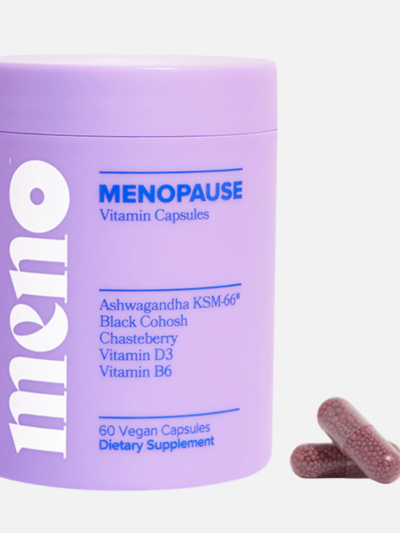 Purple container of Meno Menopause Vitamin Capsules with a list of ingredients. Two capsules are shown next to the container. Label indicates 60 vegan capsules for dietary supplement.