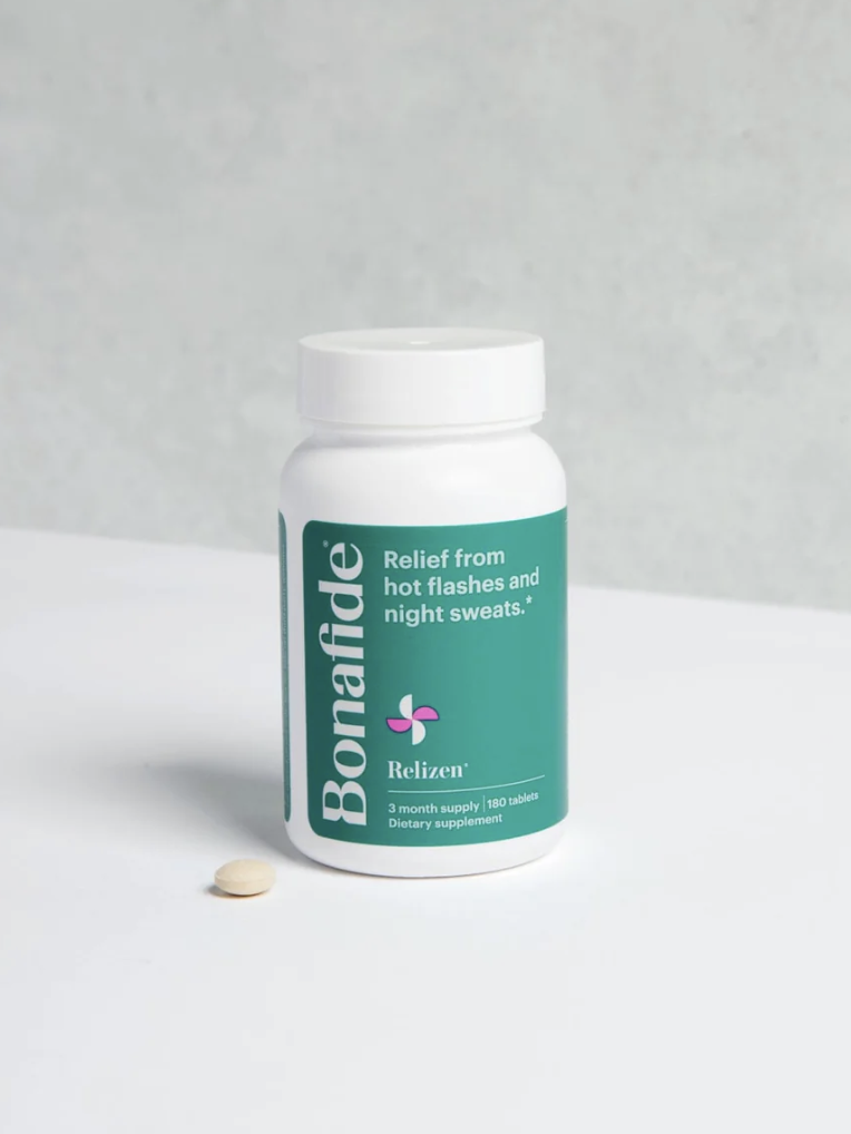 A white bottle labeled "Bonafide Relizen" is on a surface. The label mentions relief from hot flashes and night sweats. A single pill is placed next to the bottle.