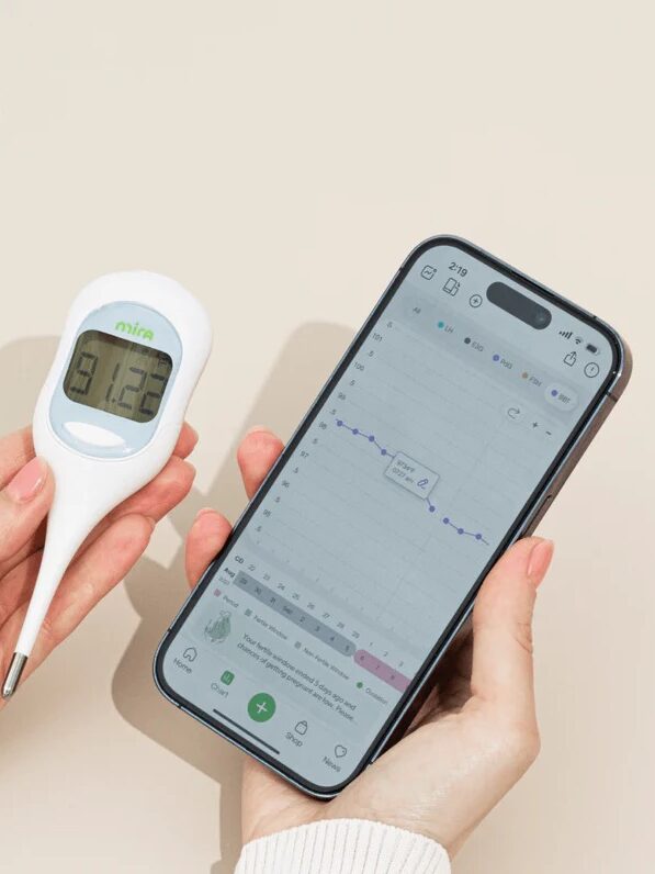 A Mira BBT thermometer next to its smartphone app. 