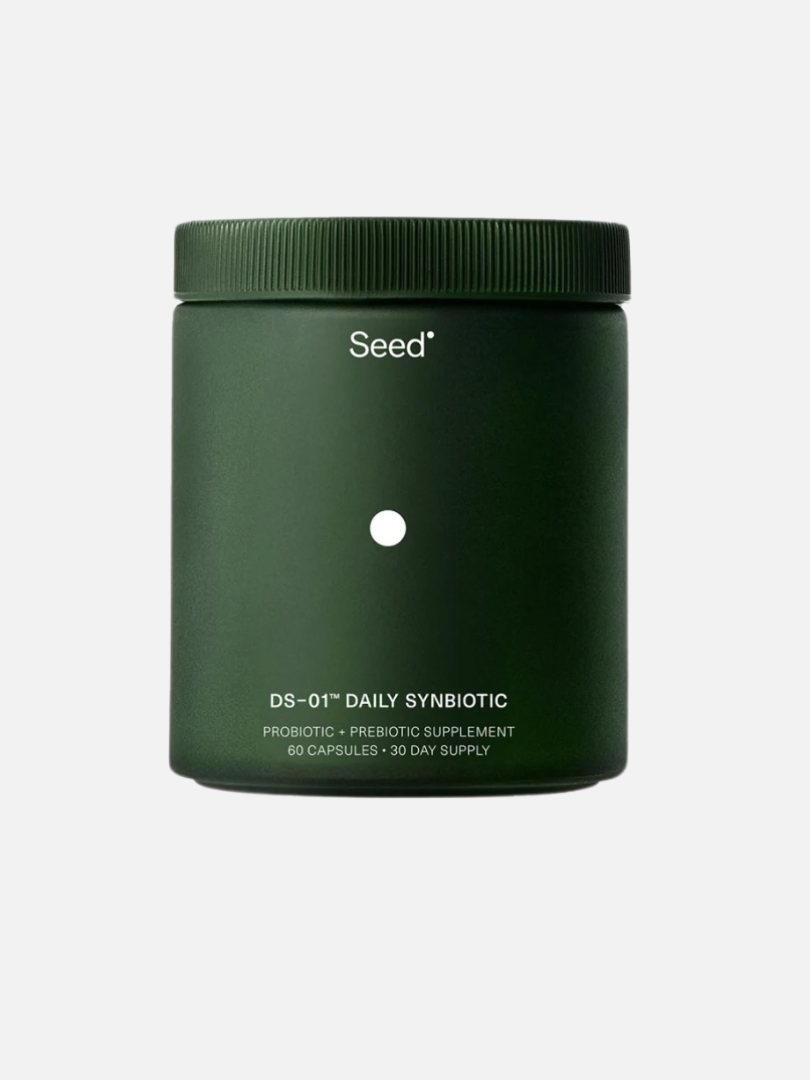 A dark green container with a label reading "DS-01™ Daily Synbiotic" from Seed. The label indicates it contains a 30-day supply of probiotic and prebiotic supplements with 60 capsules.