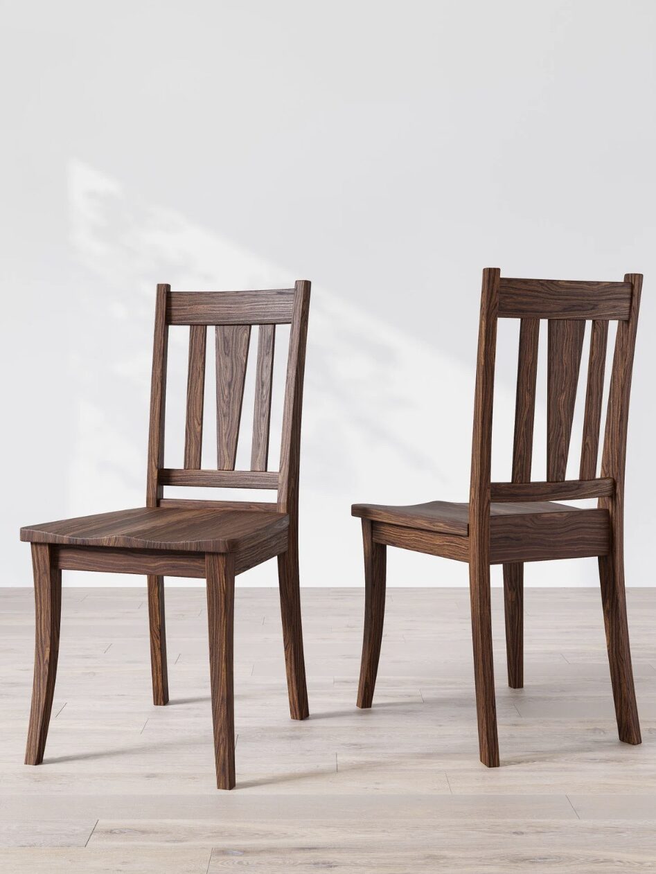 Two wooden chairs with slatted backs and seats are positioned on a light-colored wooden floor in front of a plain white wall. One chair faces forward, the other is angled to the side.