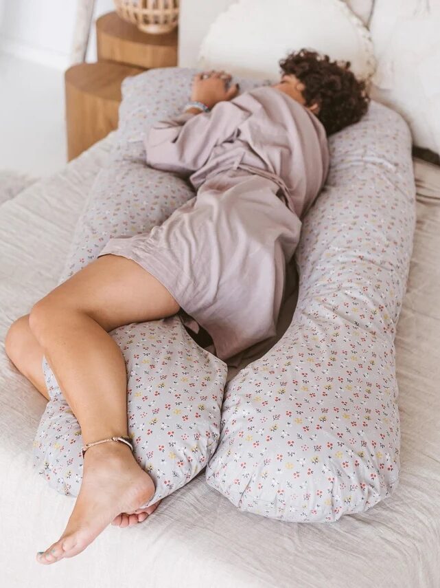 A model sleeping in a MINICAMP body pillow. 