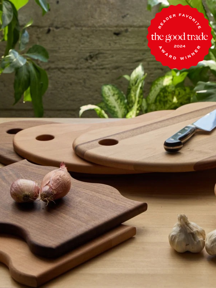 A variety of Avocado cutting boards stacked on one another on a kitchen counter. 