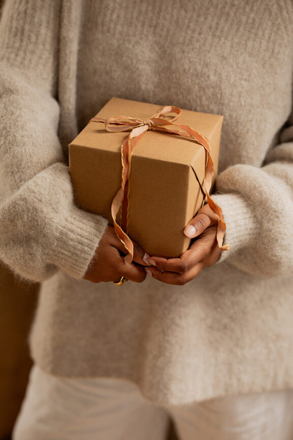 A model holding a gift box.