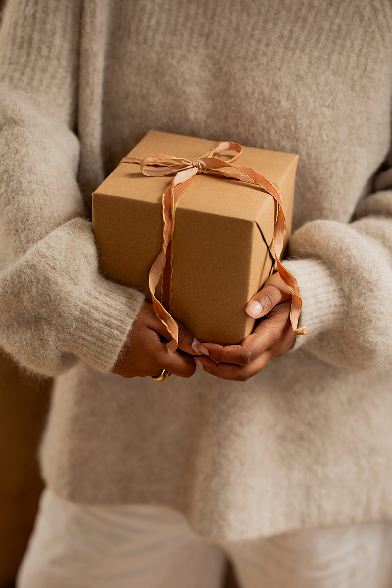 A model holding a gift box.