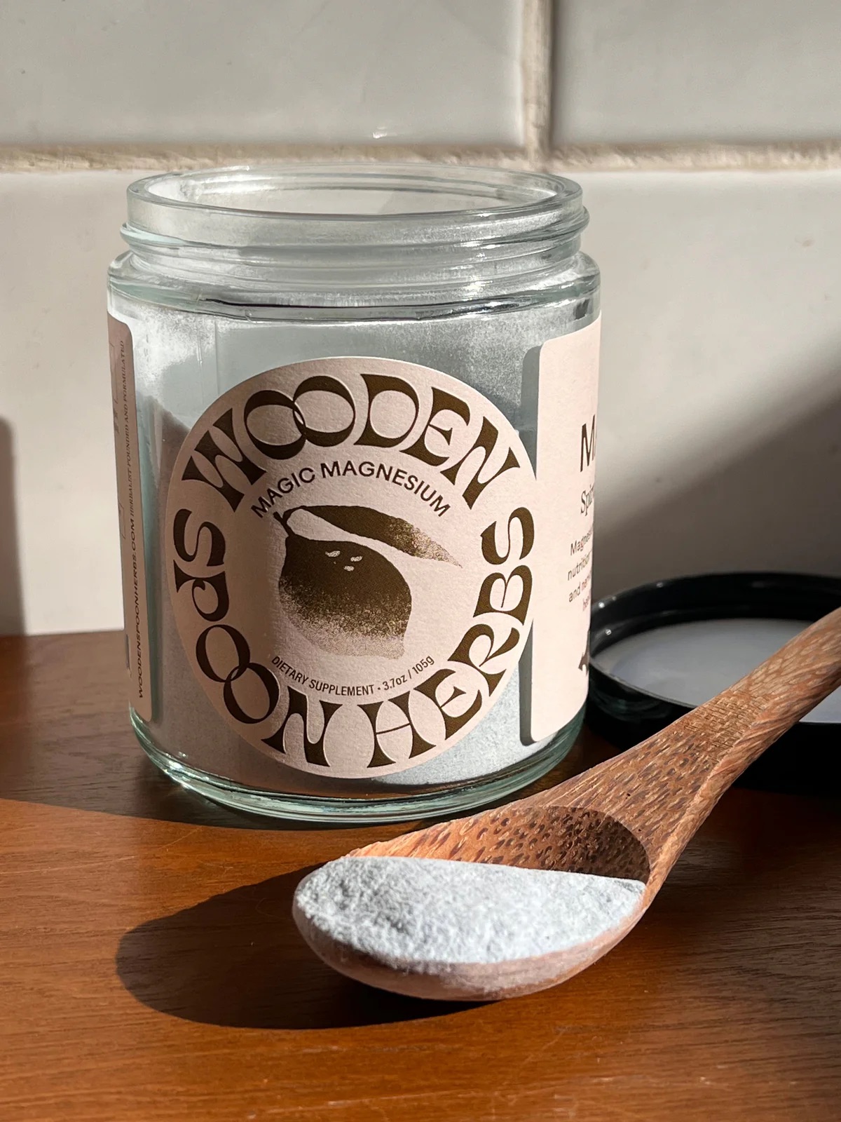 An open jar of Wooden Spoon Herbs Magic Magnesium. 