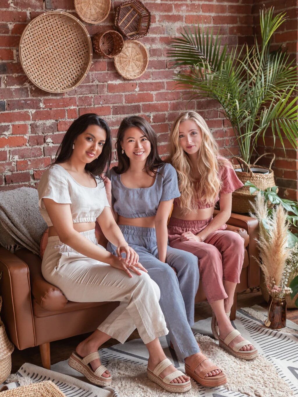 Three model sat next to one another wearing Lovanie petite clothing.