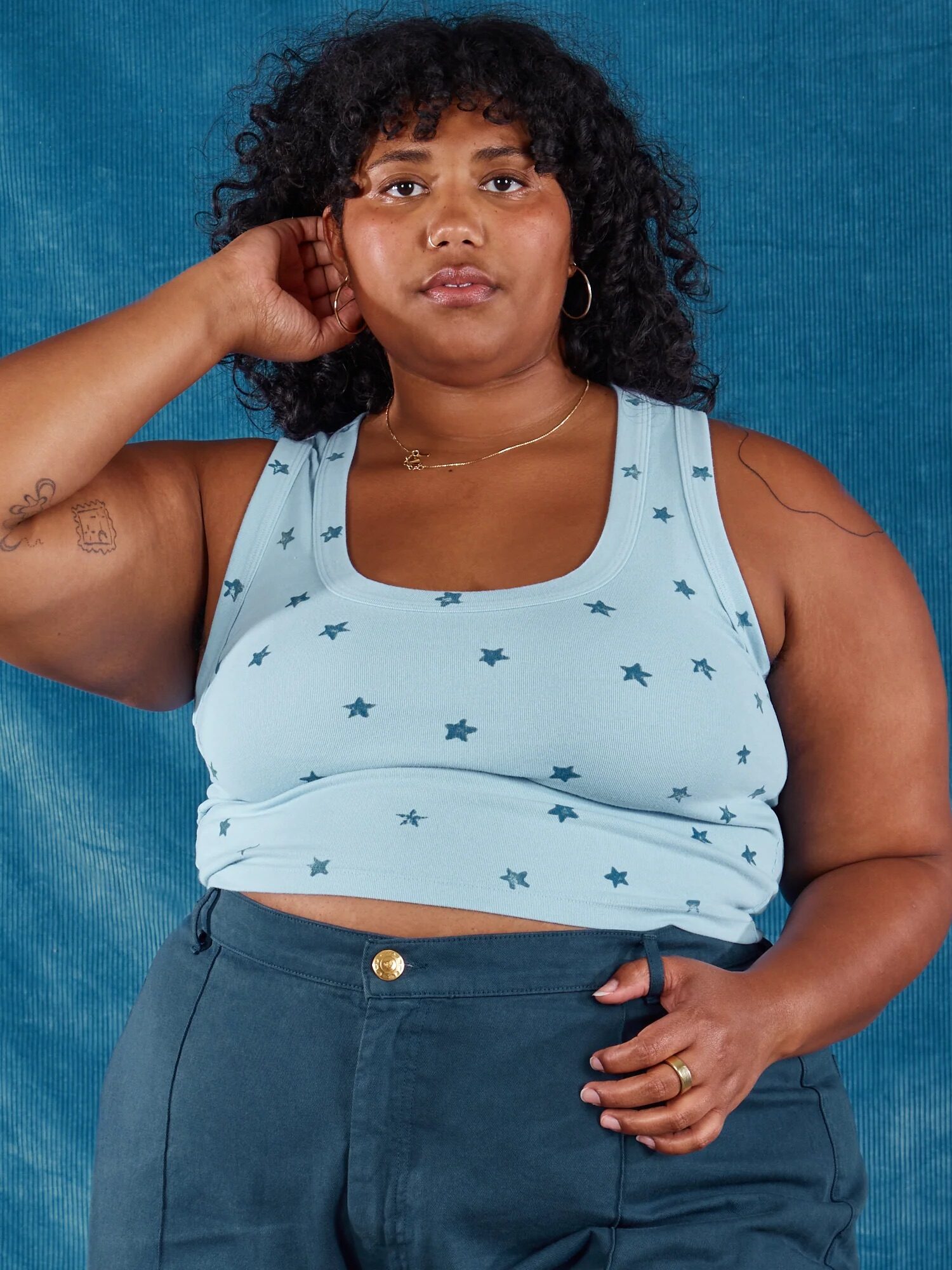 A plus size model wearing a light blue tank with stars from Big Bud Press. 