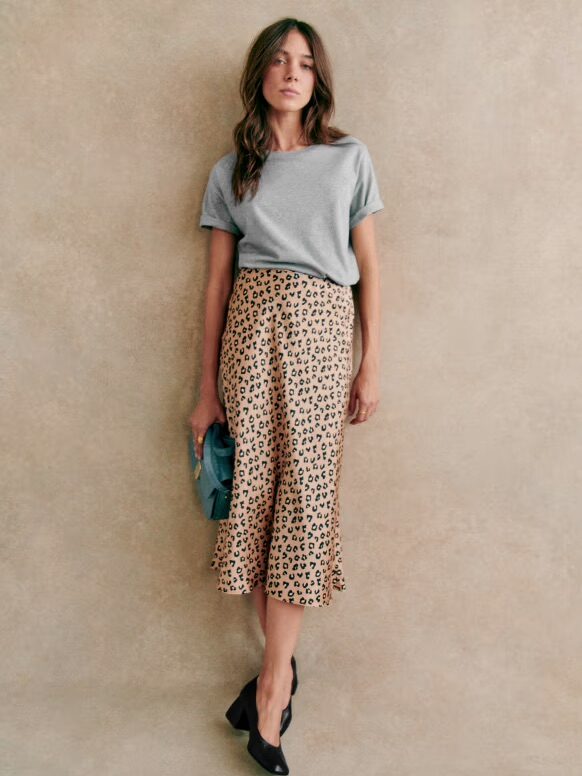 A model wearing an Lepoard silk skirt from Sezane.