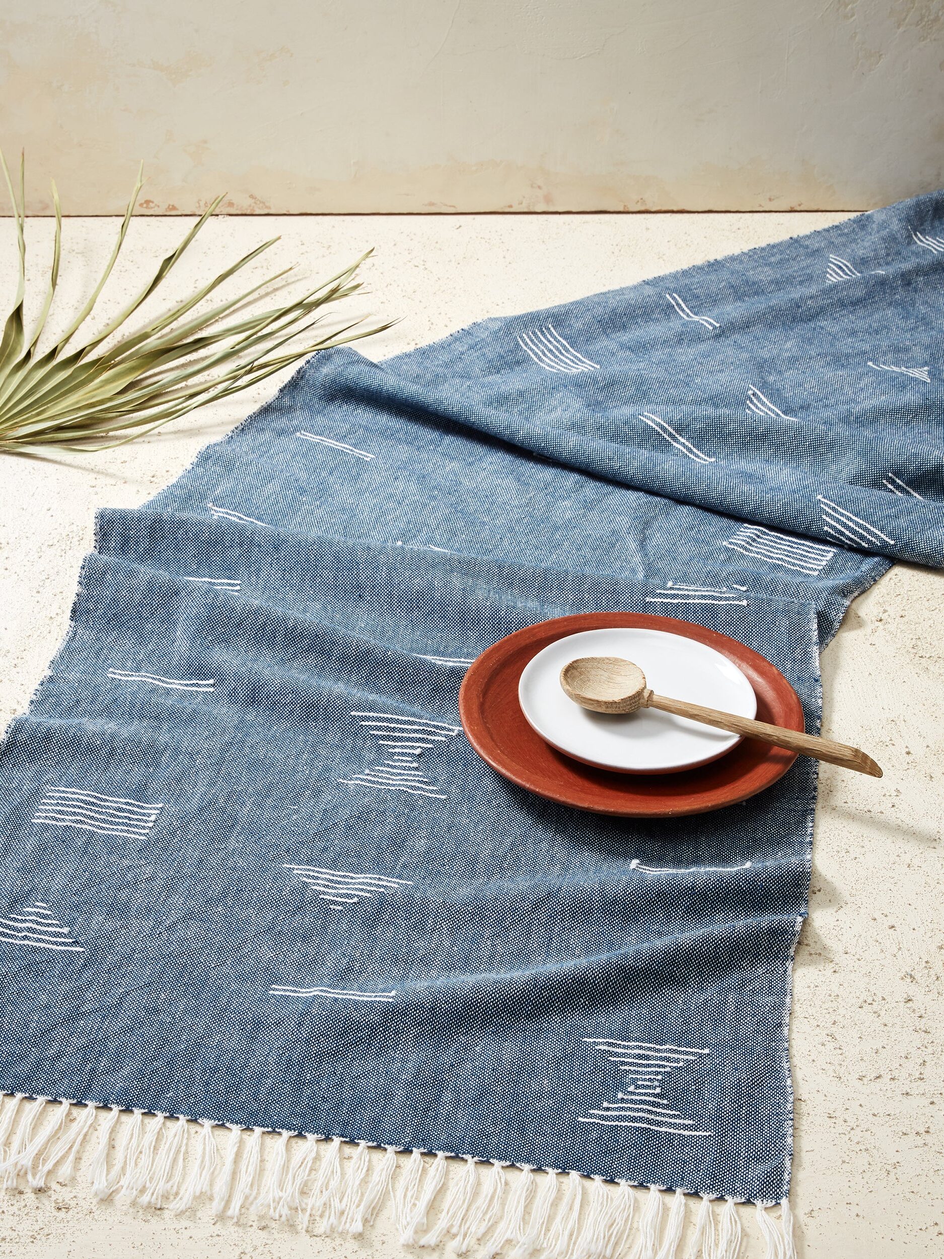 A denim blue MINNA table runner. 