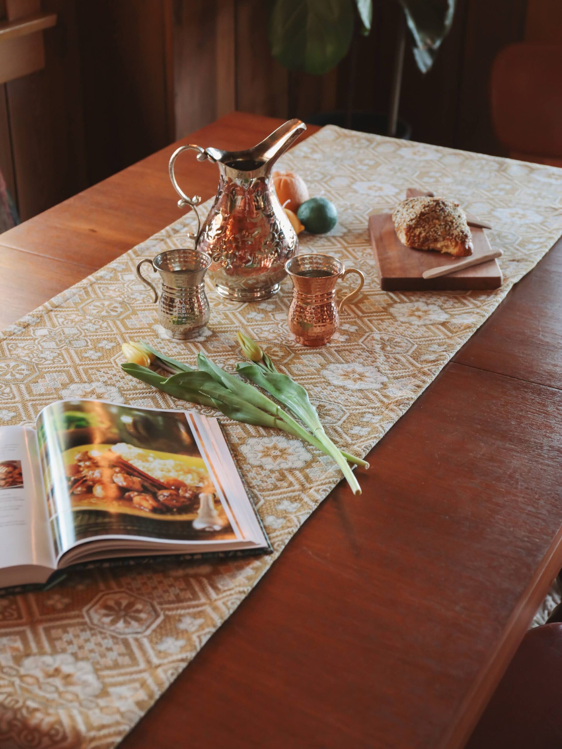 An Oddbird Mosaic table runner with a dining setup on top. 