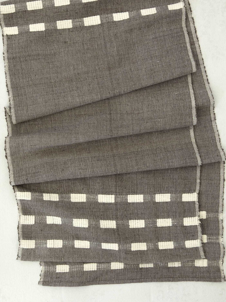 A grey table runner from Bole Road textiles. 