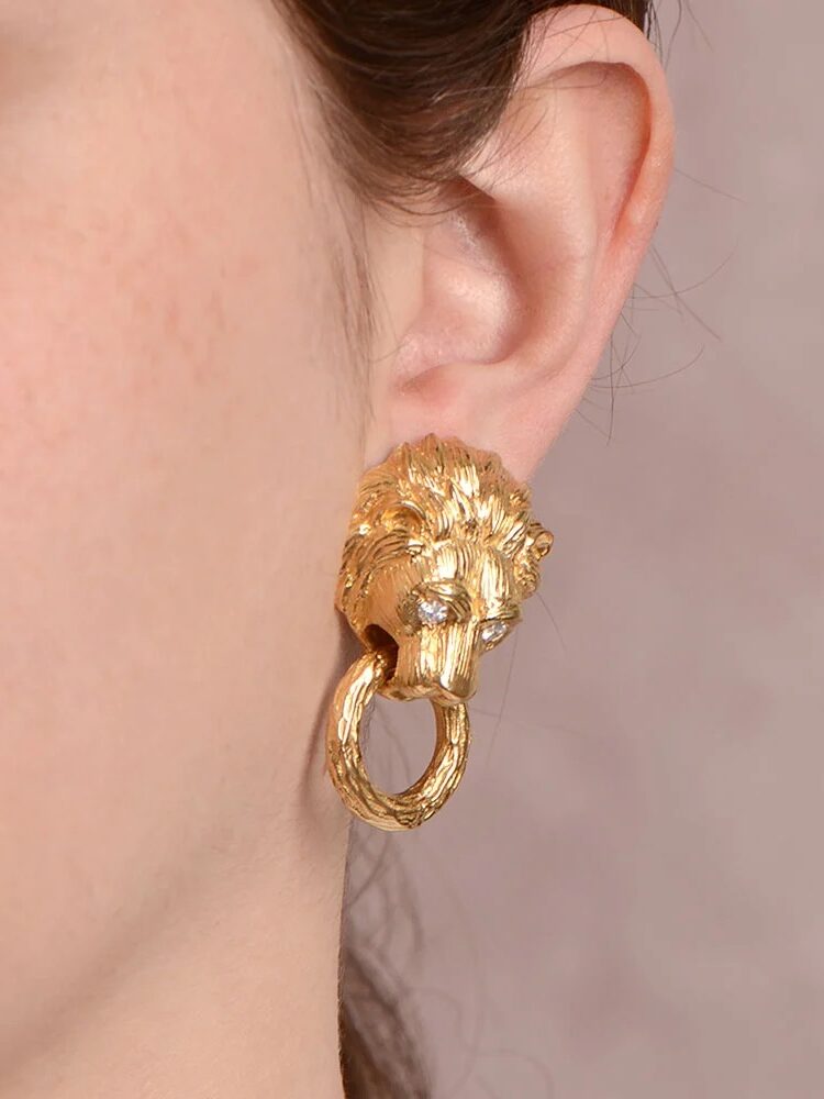 A gold lion earring. 