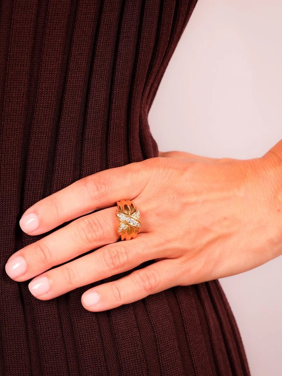 A chunky gold and crystal ring. 