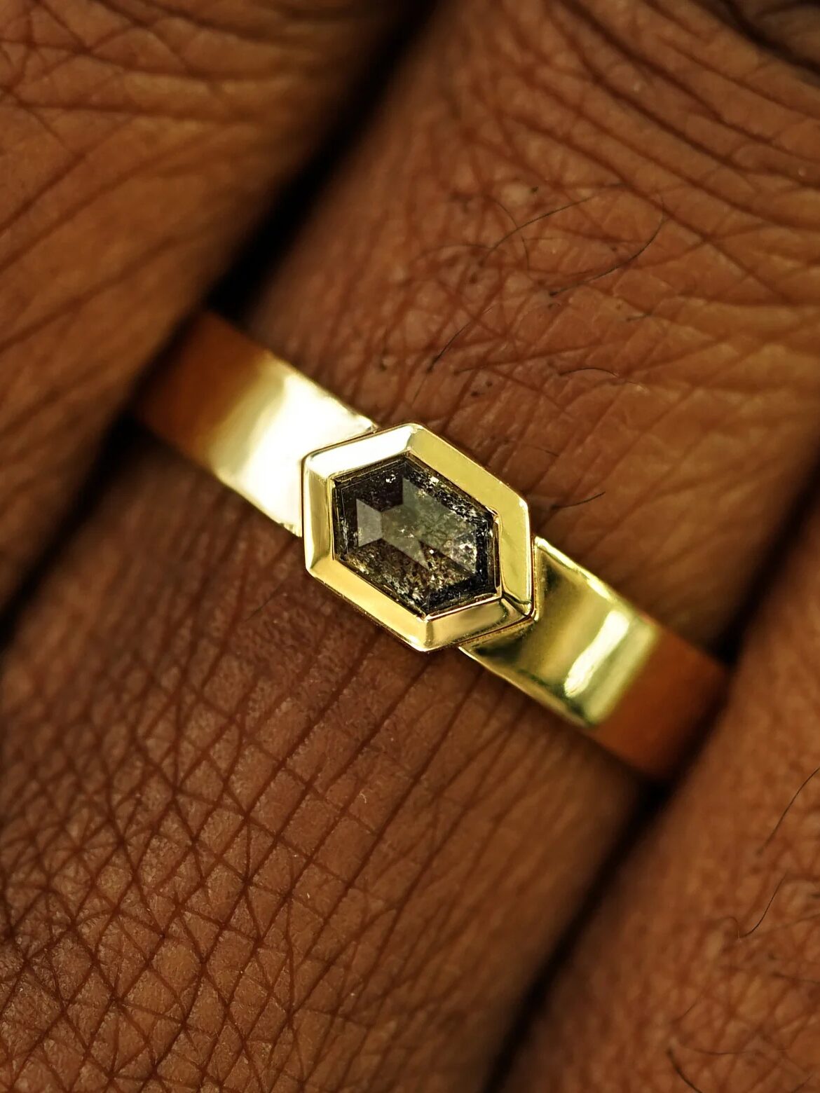 A model wearing an Automic Gold ring.