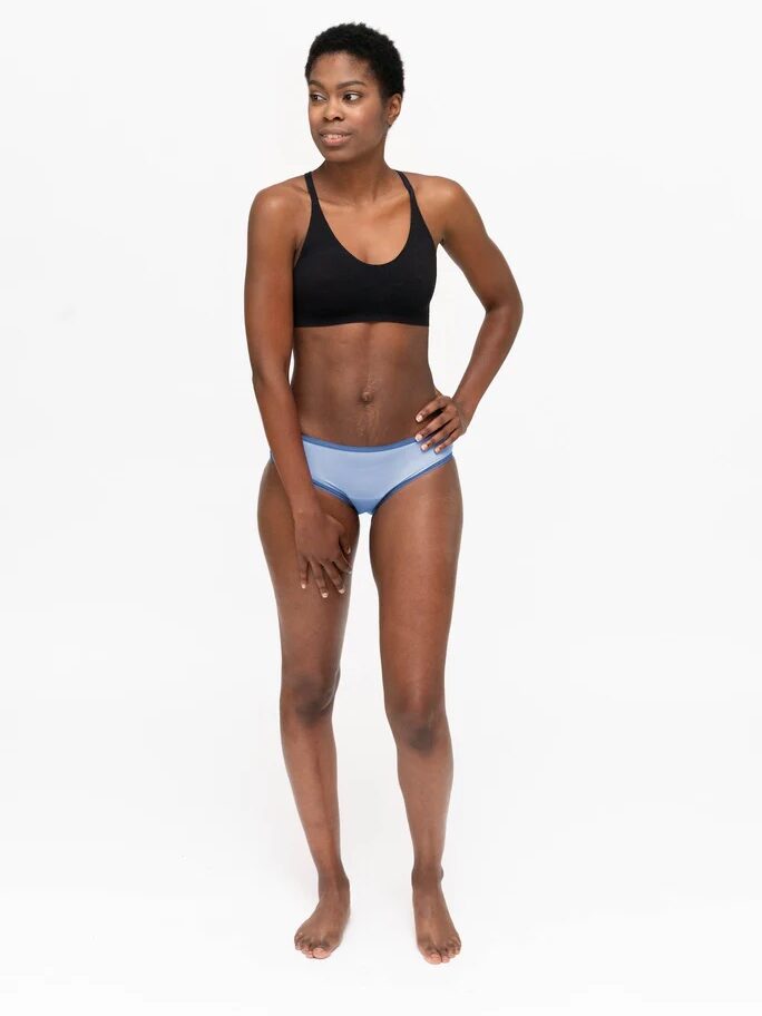 A model wearing light blue hipster Dear Kate period underwear. 